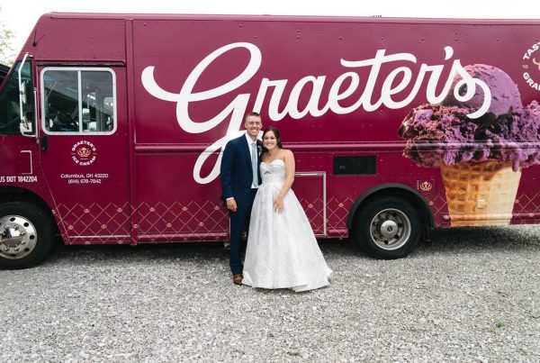 Adisyn and Carson pose in front of the Graeter’s ice cream truck at their wedding at The Grange Hall