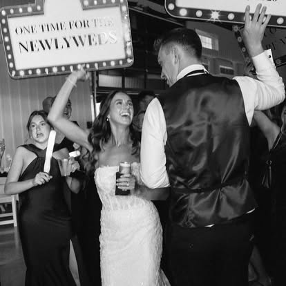 Ava and Carter dance under a light-up One Time for the Newlyweds sign